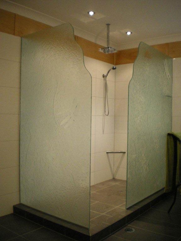 A Bathroom With a Walk in Shower and a Ceiling Fan — Frameless Shower Installations In Maroochydore, QLD