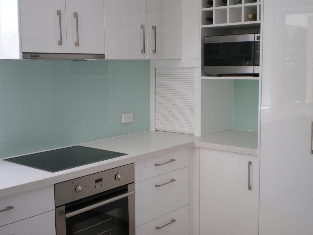 A Kitchen With Stainless Steel Appliances and White Cabinets — Frameless Shower Installations In Maroochydore, QLD