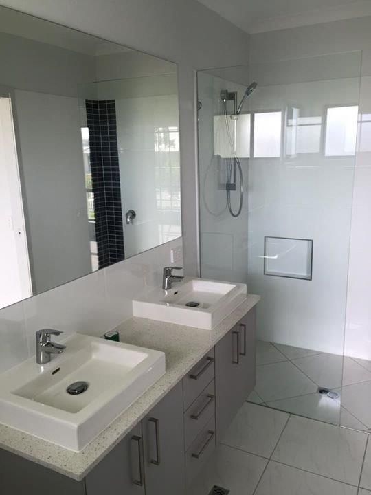 A Bathroom With Two Sinks and a Walk in Shower — Frameless Shower Installations In Maroochydore, QLD