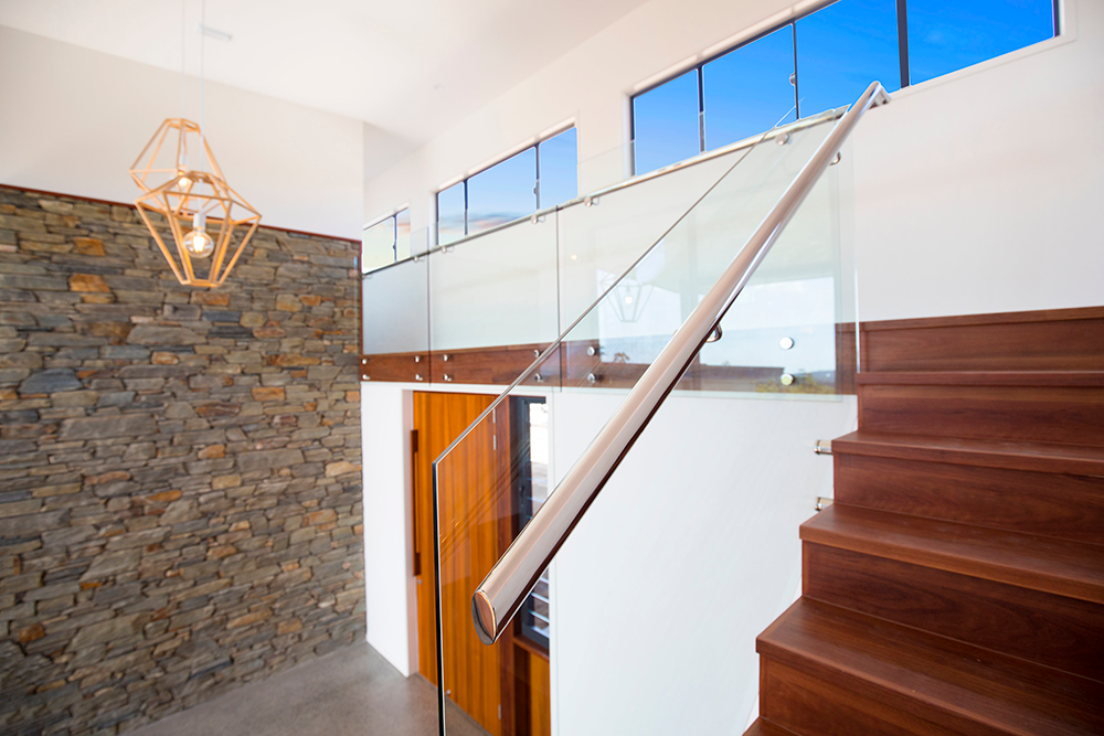 Wooden Staircase with Glass Railing in a Modern Home — Frameless Shower Installations In Maroochydore, QLD