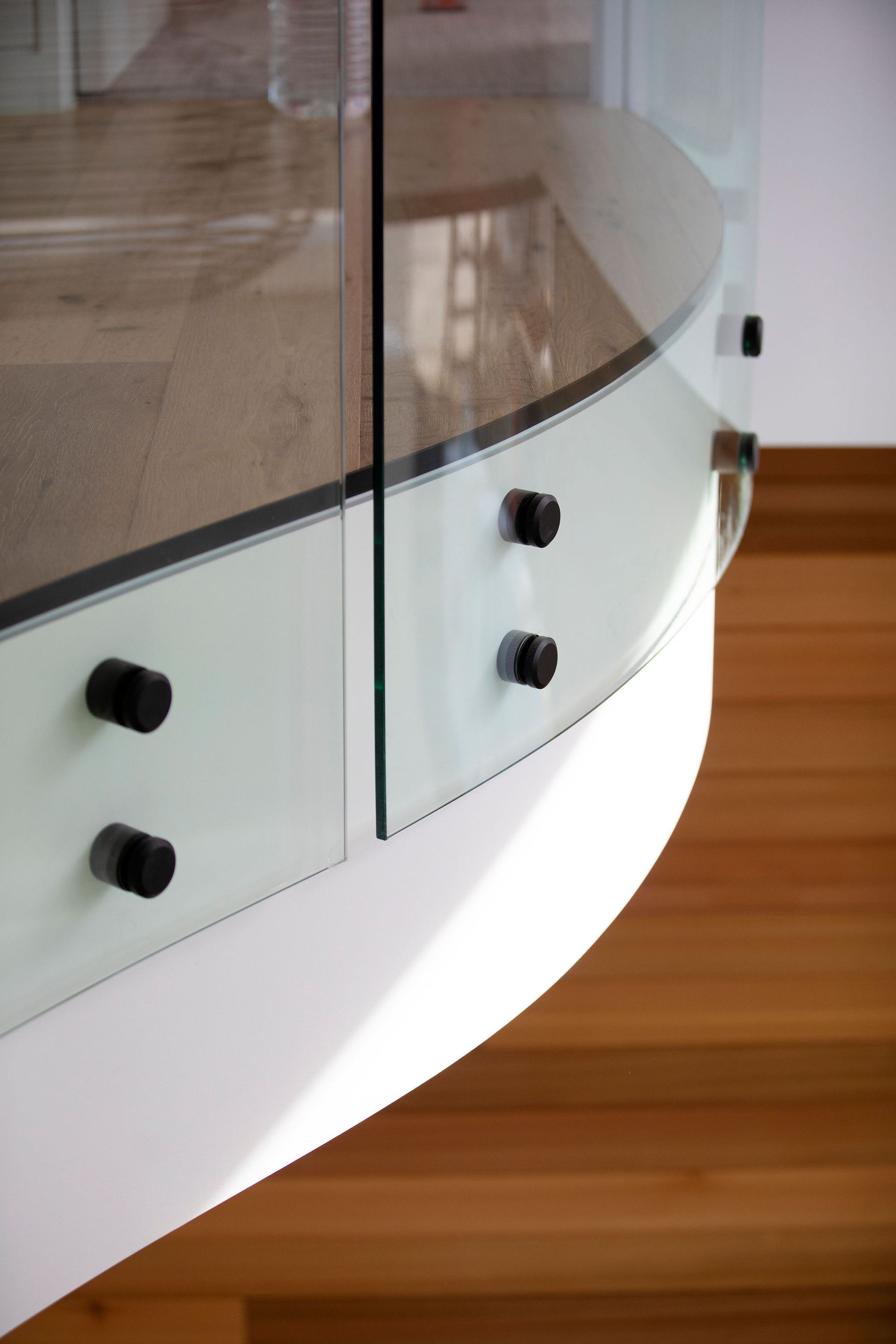 A Staircase With a Glass Railing and a Wooden Floor — Frameless Shower Installations In Maroochydore, QLD