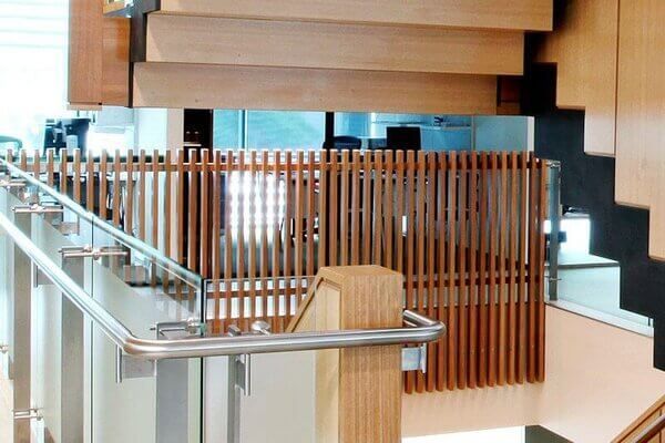 A Staircase With A Wooden Railing And A Glass Railing — Frameless Shower Installations In Maroochydore, QLD
