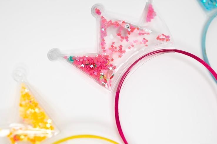 A group of headbands with crowns on them on a white background.