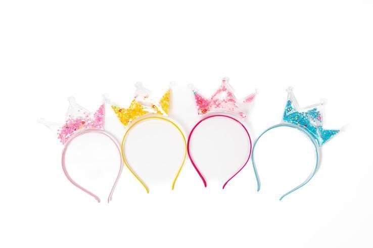 A group of headbands with crowns on them on a white background.