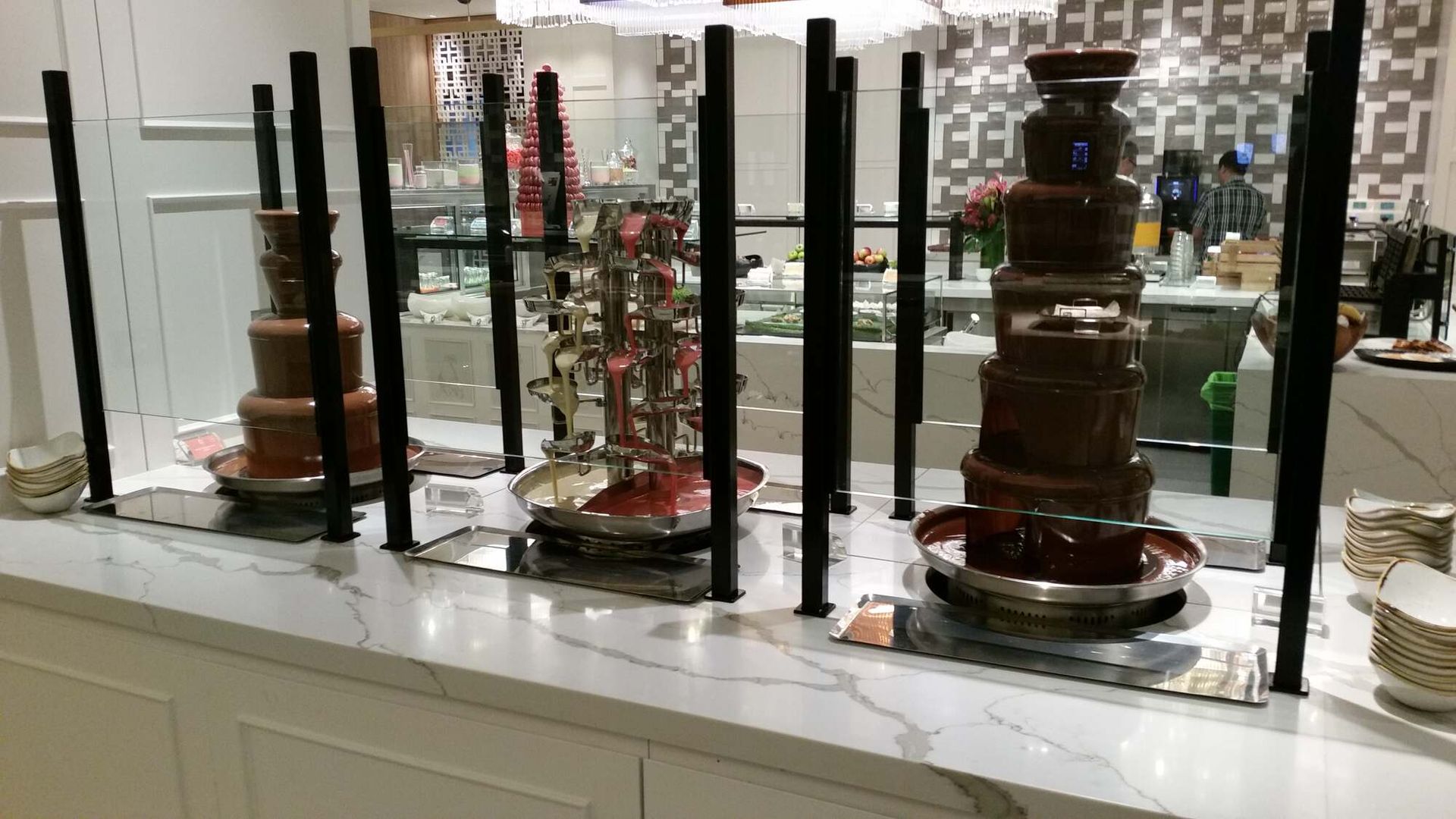 A Row of Chocolate Fountains on A Counter in A Restaurant — Sheridan Stone Aust in Toormina, NSW