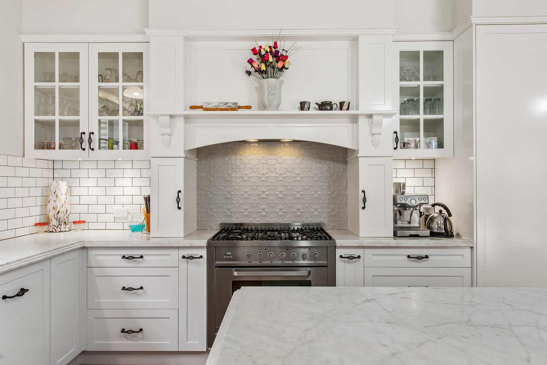 A Kitchen with White Cabinets and A Stove Top Oven — Sheridan Stone Aust in Coffs Harbour, NSW