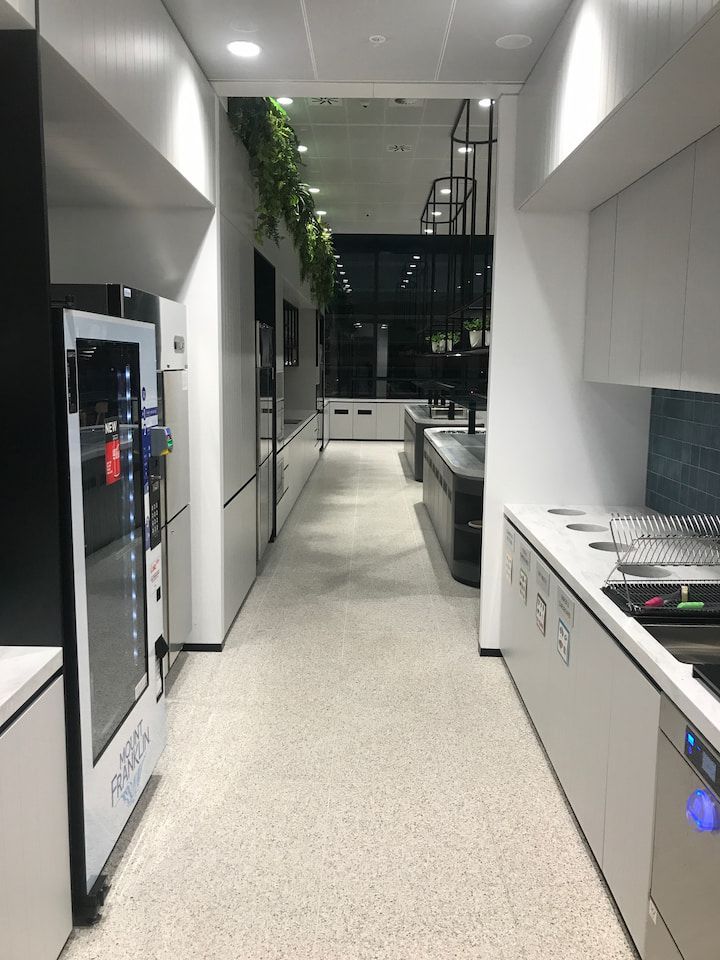 A Long Hallway Leading to A Kitchen with A Vending Machine — Sheridan Stone Aust in Toormina, NSW