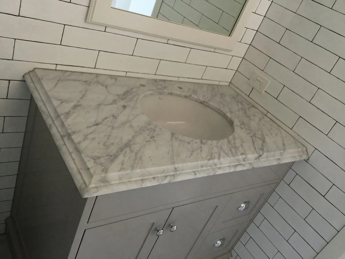 A Bathroom Vanity with A Sink and A Mirror — Sheridan Stone Aust in Port Macquarie, NSW