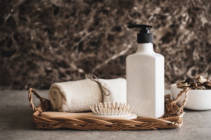 Bath time. Shampoo bottle and hairbrush