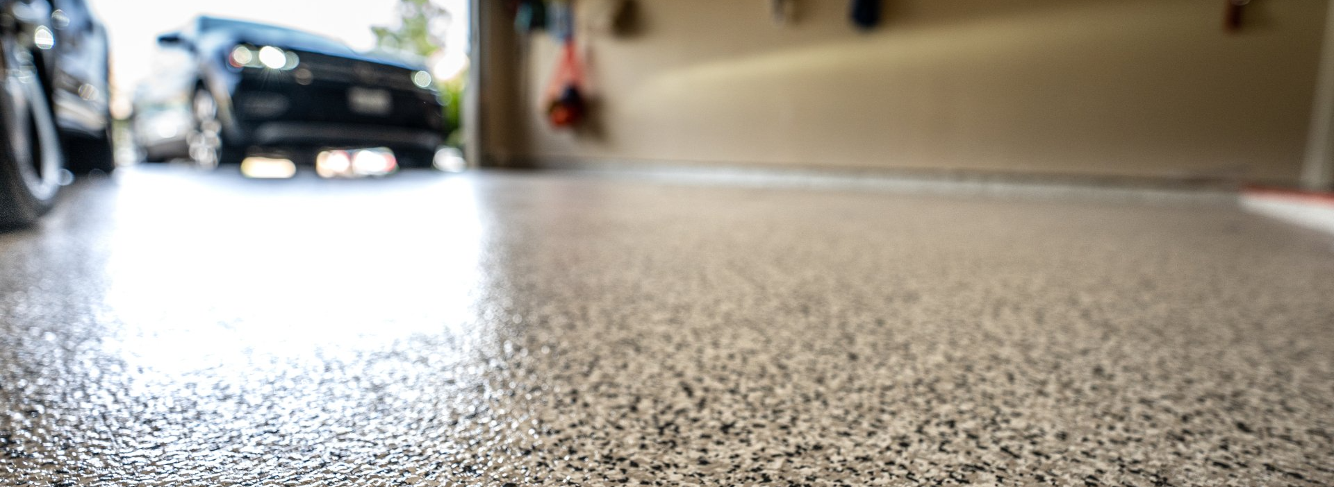 A car is parked in a garage with a concrete floor.