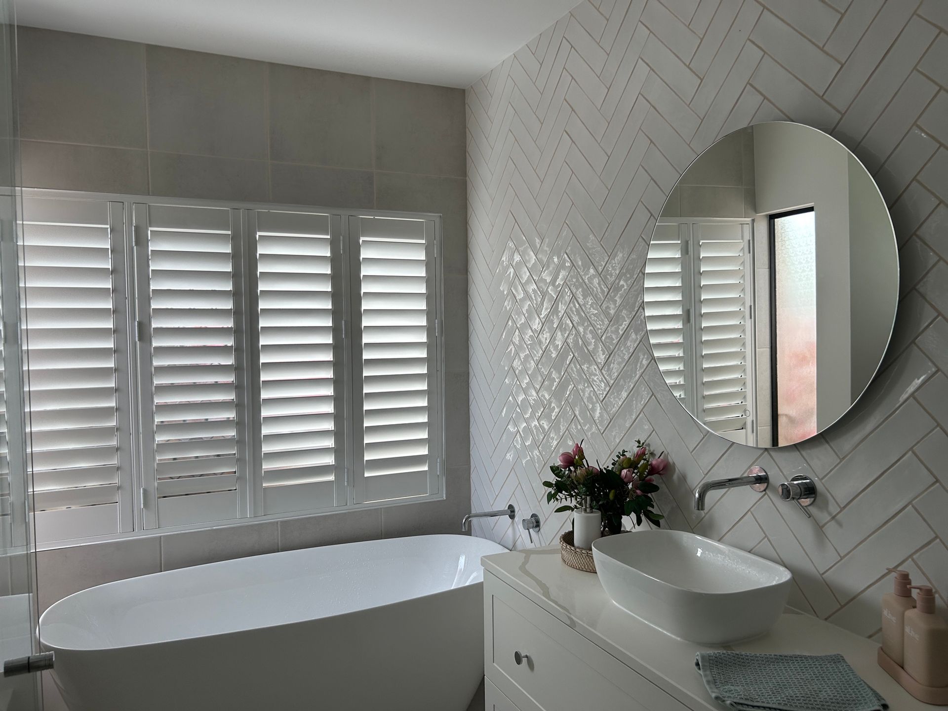 a bedroom with a large bed and a ceiling fan