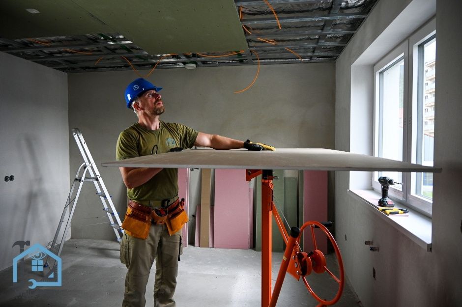 Male residential contractor preparing to hang drywall on a ceiling in Markham, Ontario.