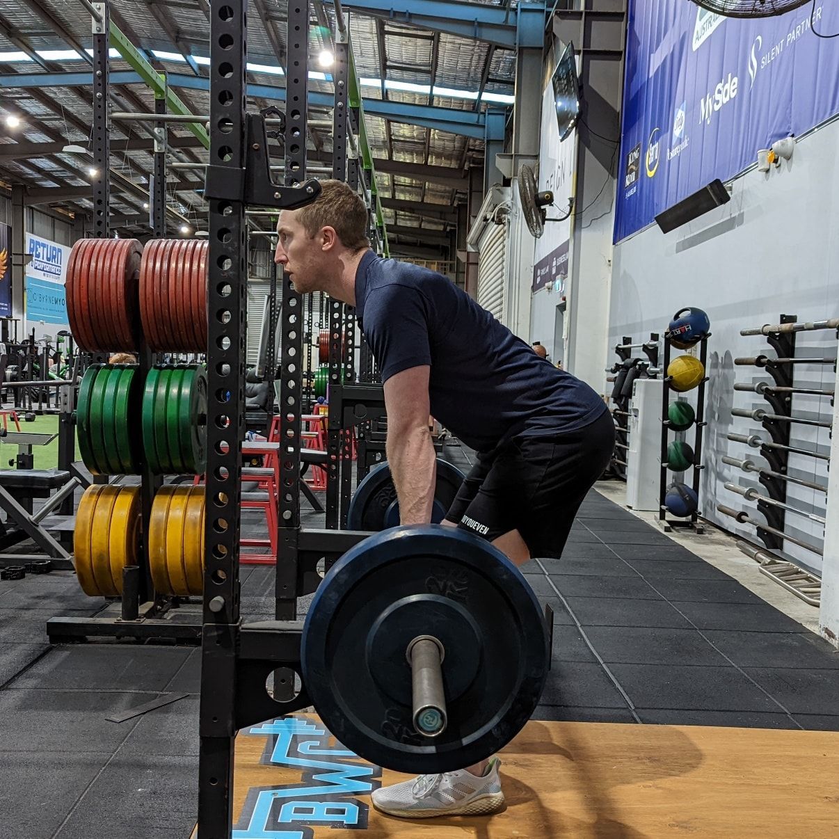 Physiotherapist Demonstrating Balance Exercise on One Leg in a Gym Setting — Return to Performance Physiotherapy in Epsom, VIC