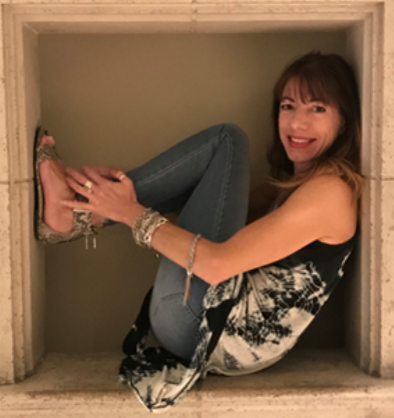 A woman is sitting in a box with her legs crossed