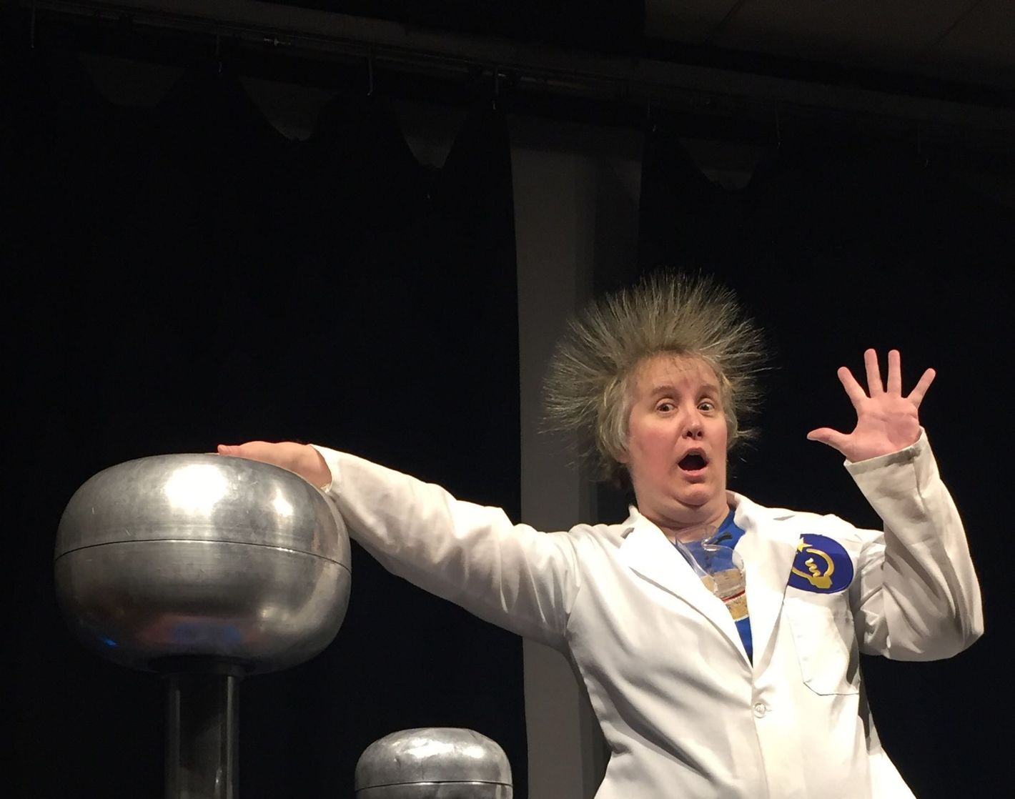 A ScienceWorks Educator showing off the Vandergraaf generator. 