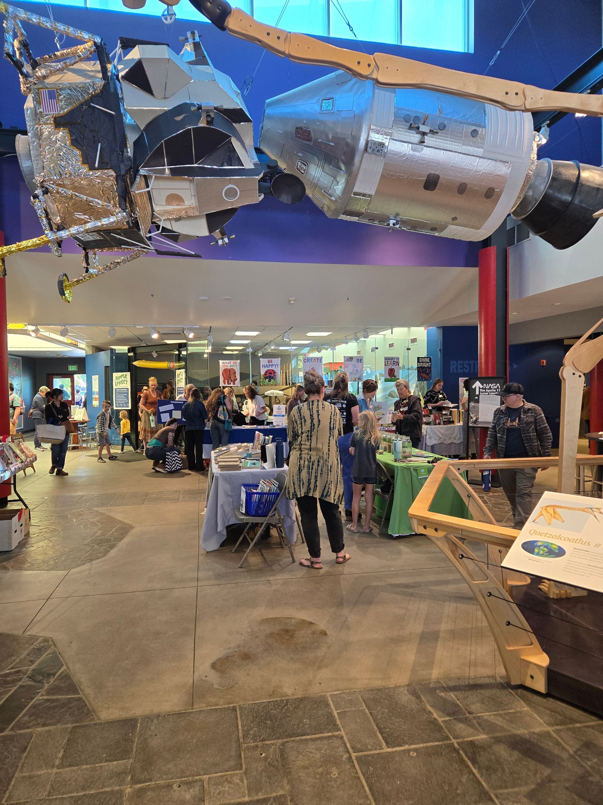 Kranzler Hall during books and brews. there are various vendors at tables around the room and visitors browsing