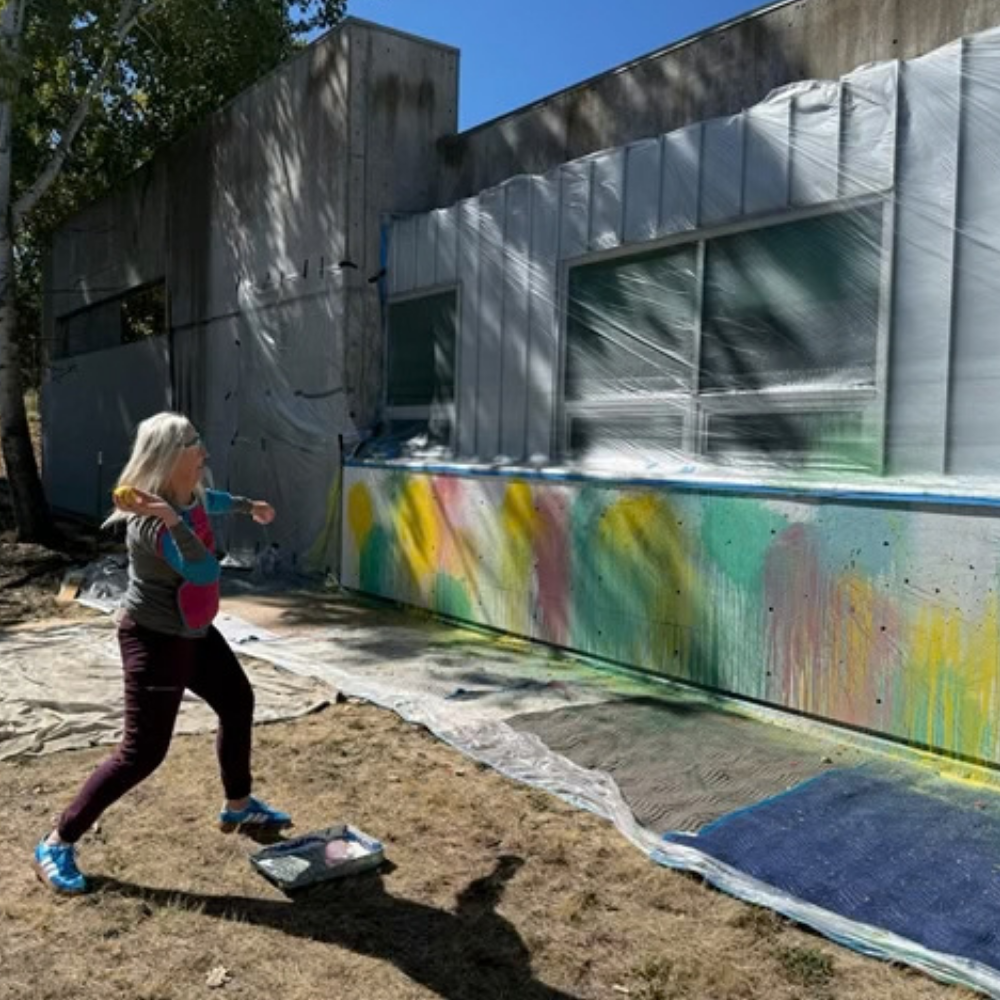 a woman People paint balloons at a scienceworks wall