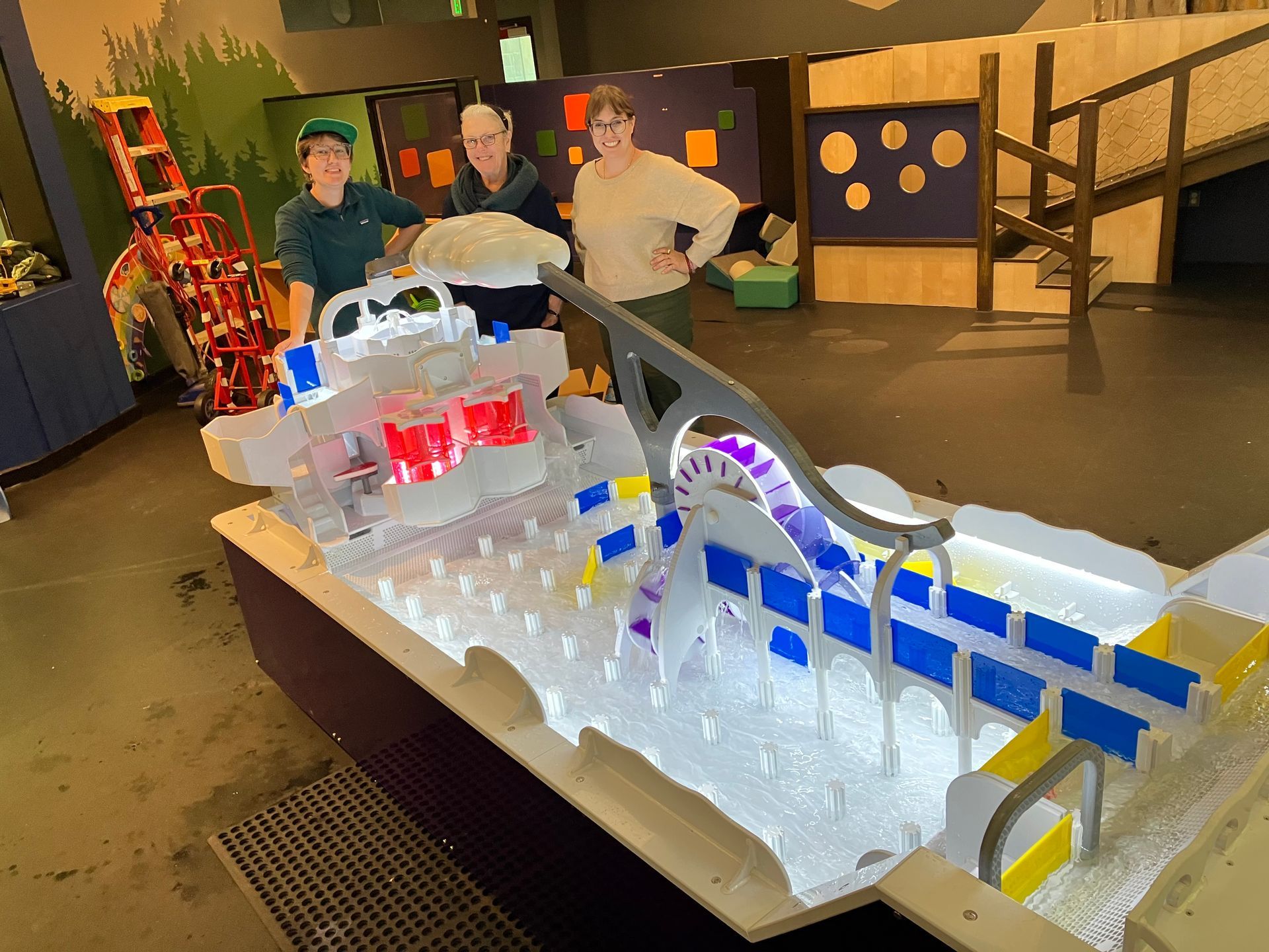 Liz, Diane, and Johnnie pose with the new water table exhibit