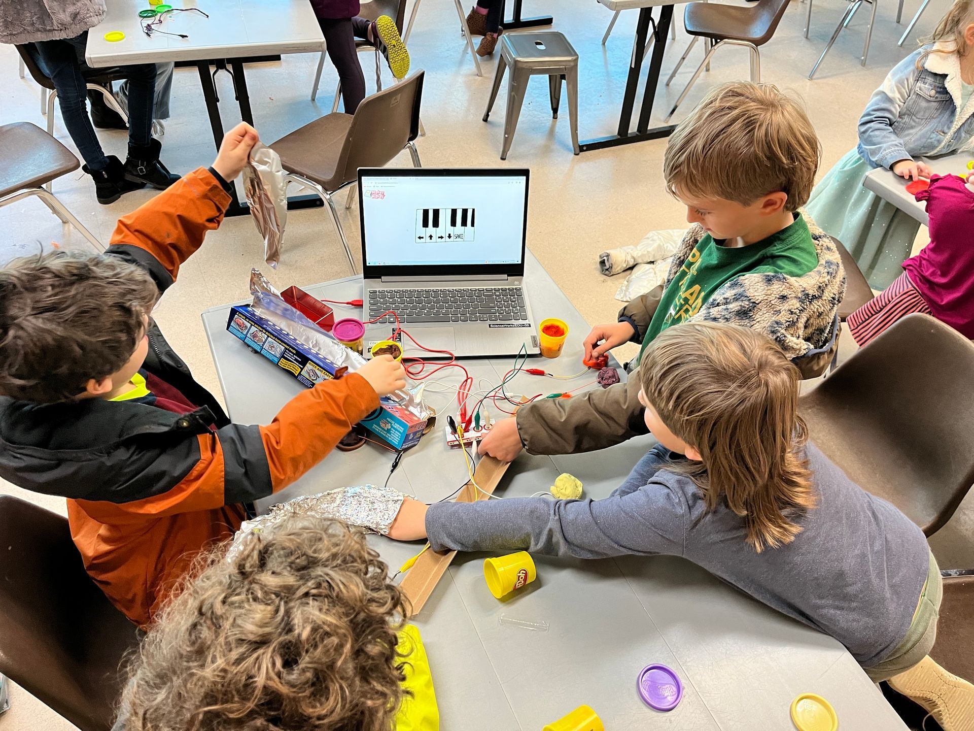Campers crafting instruments during ScienceWorks' Junkyard Orchestra camp