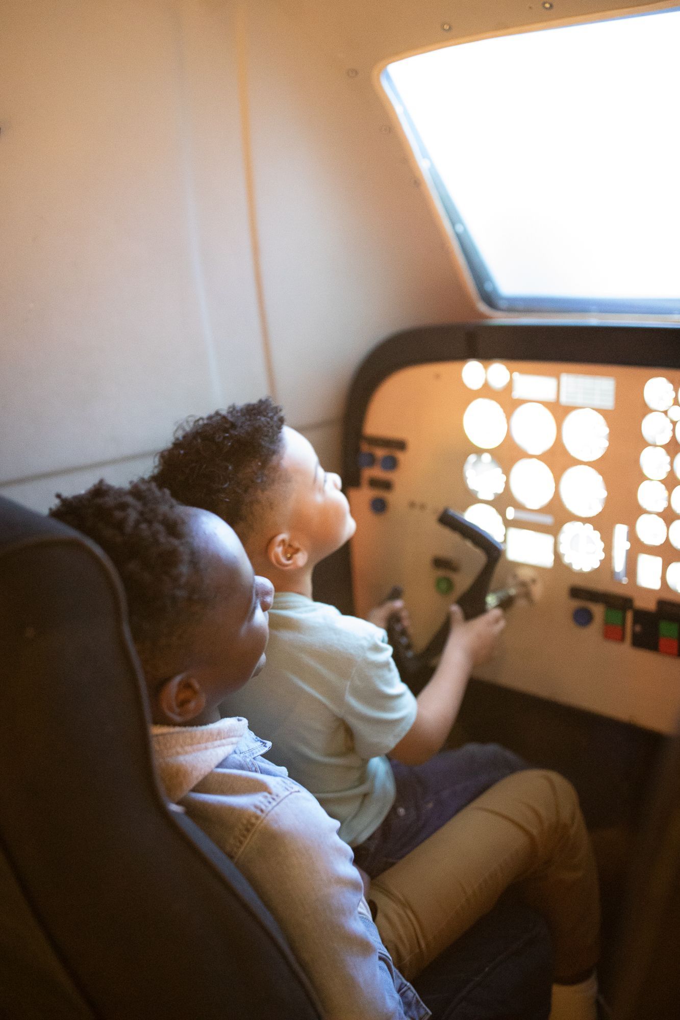 Brothers playing on the Little Flight Simulator at ScienceWorks Museum in Ashland Oregon