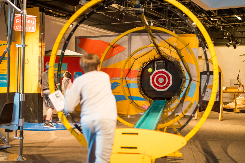 A boy participating in the Vertical Jump Exhibit as part of ScienceWorks' Sportsology Collection.