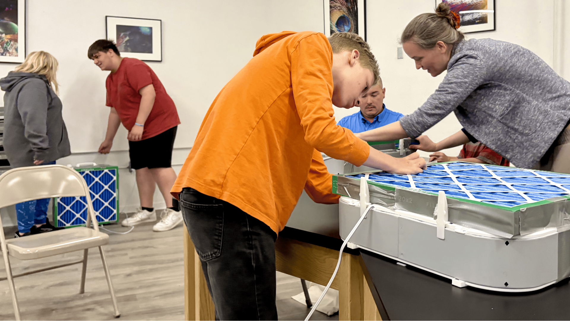 Visitors learn how to make DIY air filters in a workshop at Sparking Action