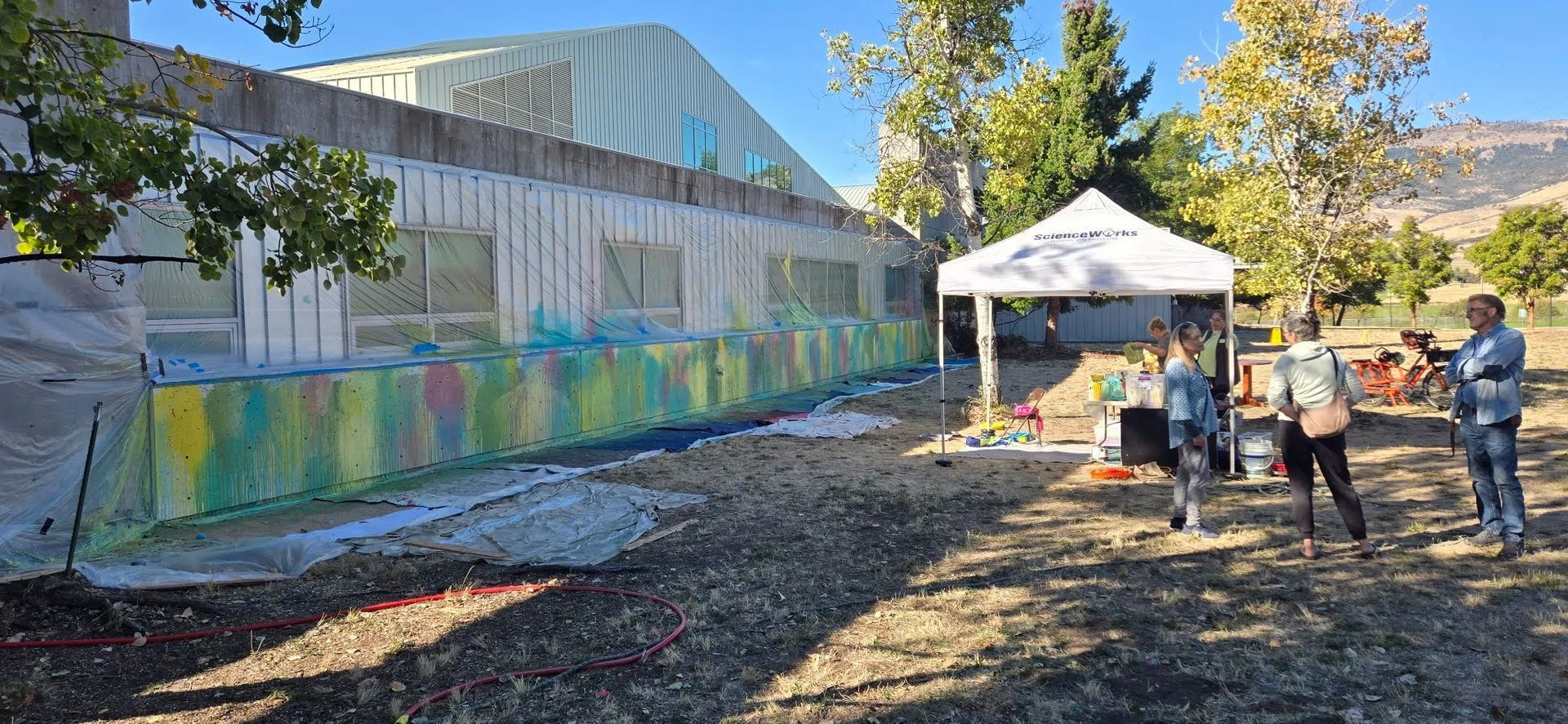 Colorful mural on a low wall  with windows
