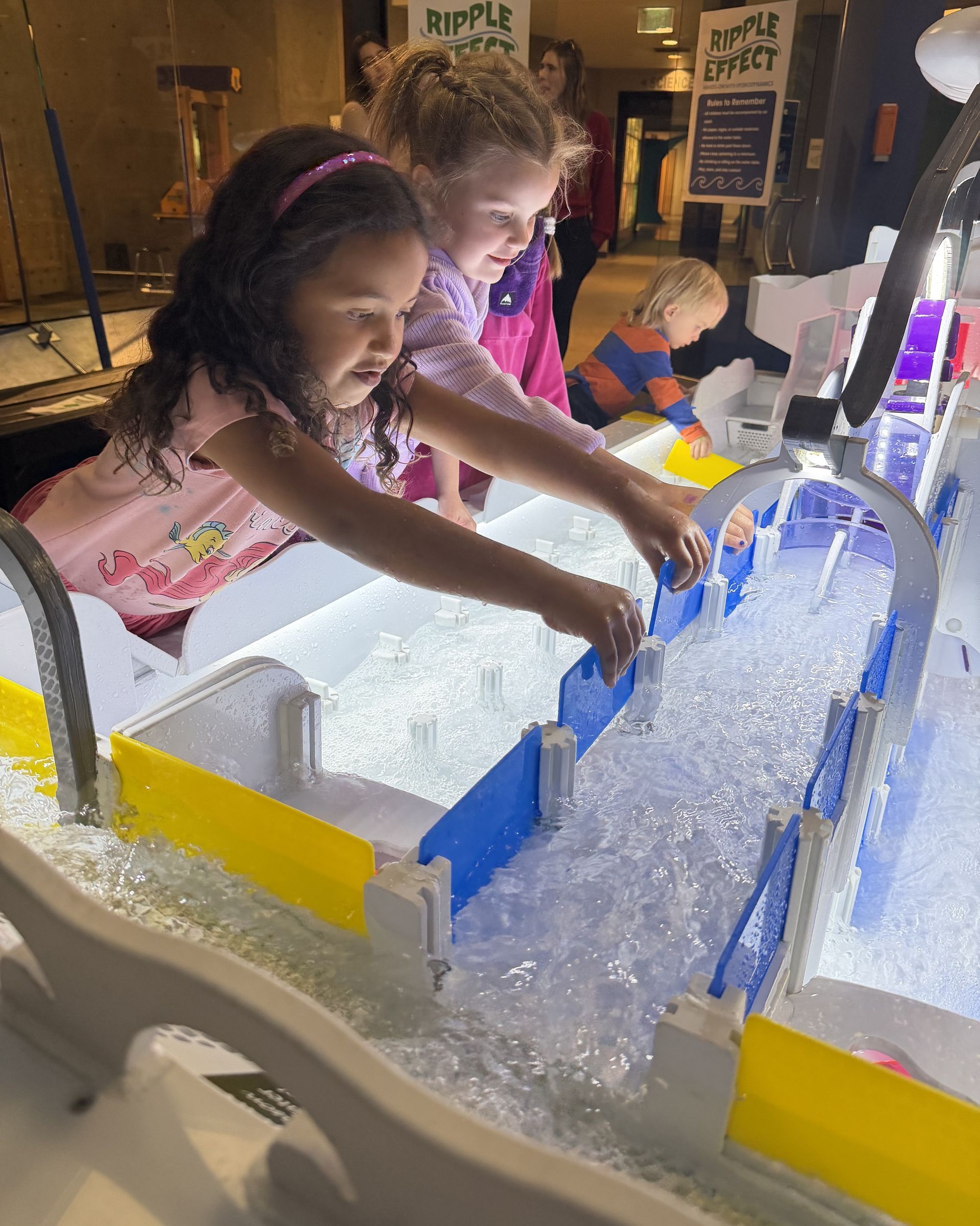 Children playing with water table exhibit at ScienceWorks Hands-On Museum.