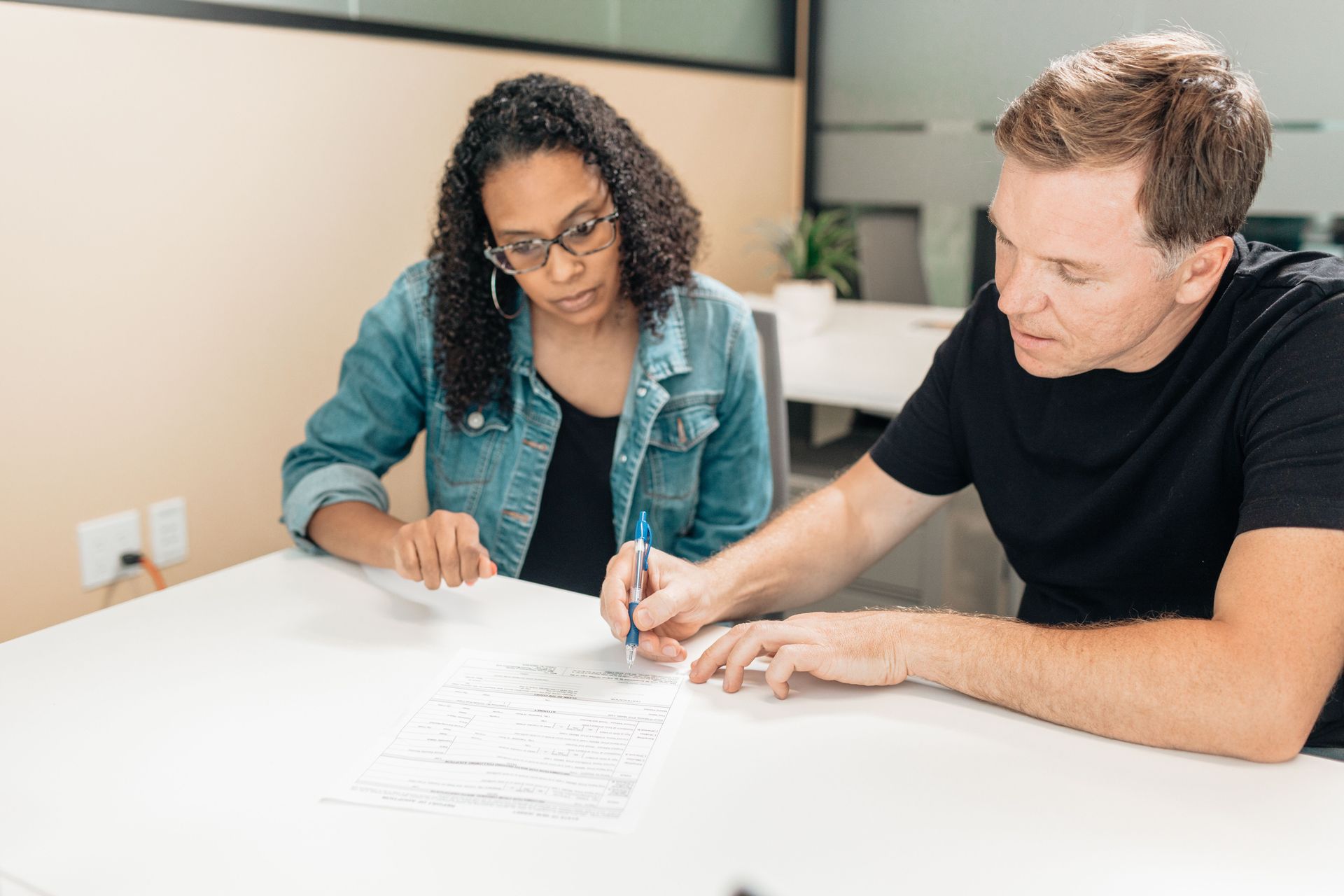 Attorney and small business owner reviewing an LLC operating agreement to prevent ownership disputes