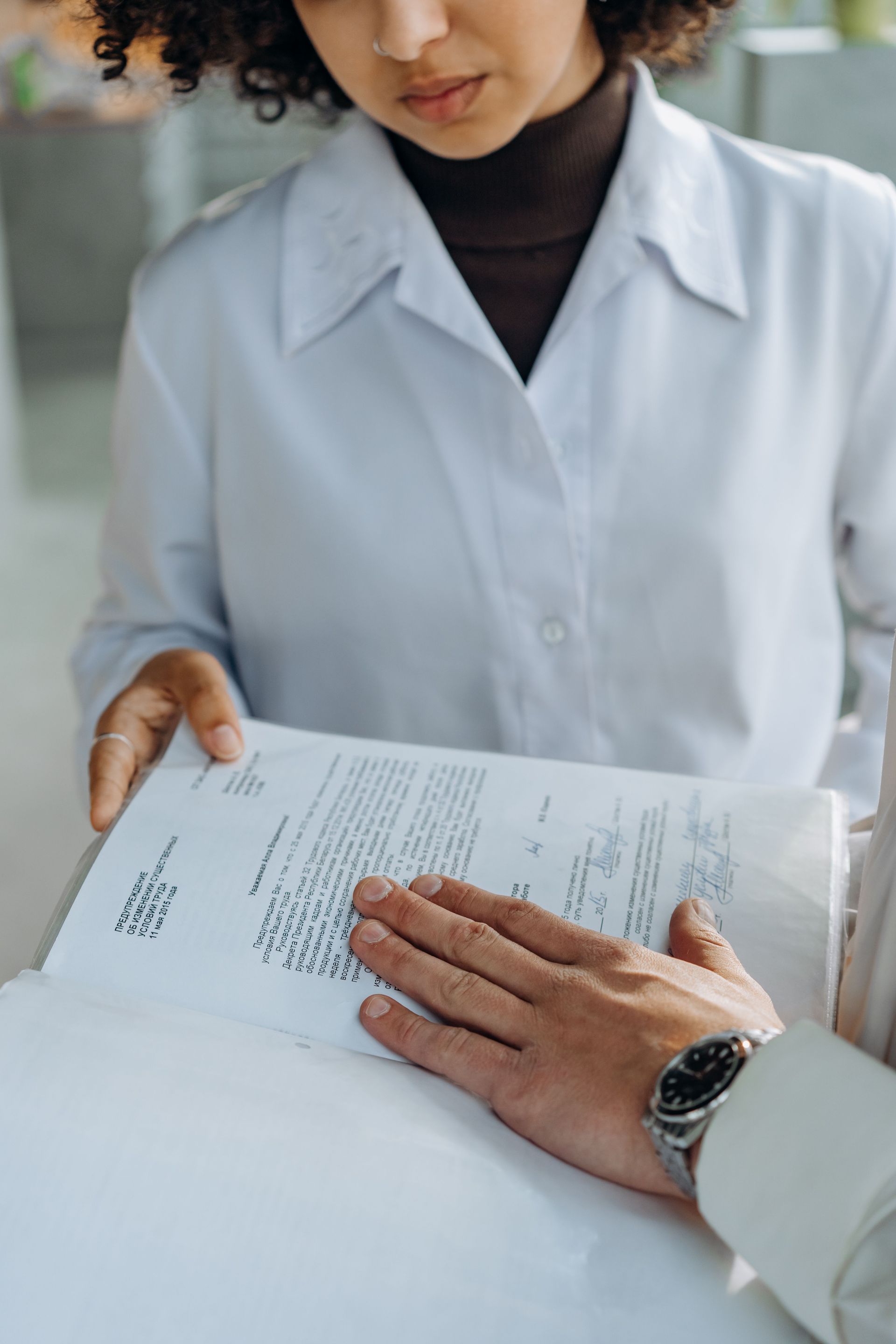 Associate dentist reviewing an employment agreement before signing a dental practice contract