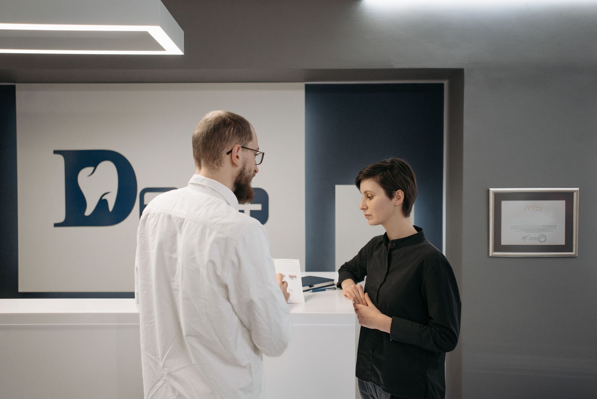 Dentist reviewing legal documents before buying a dental practice and completing a practice transition