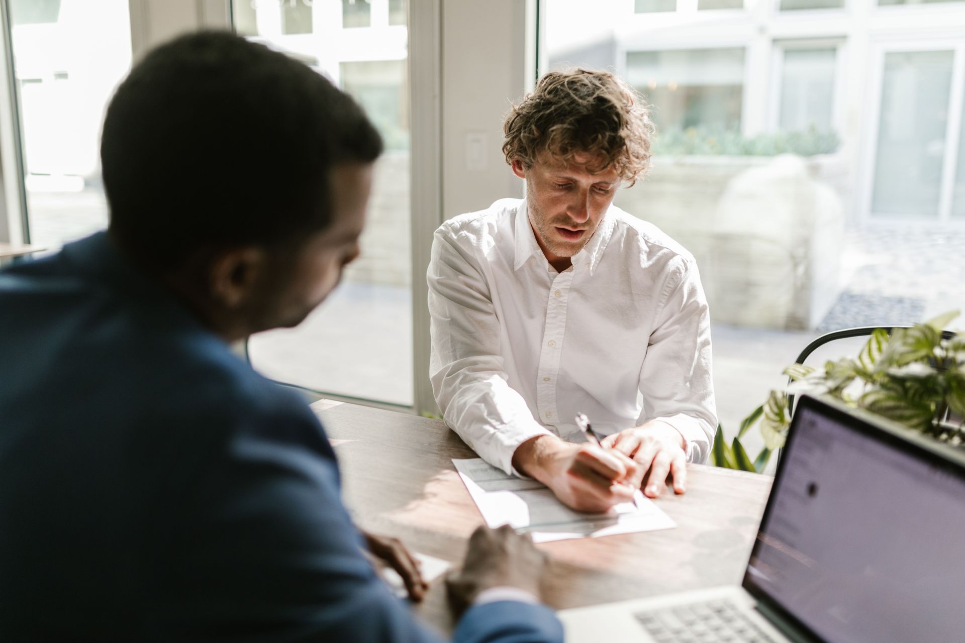 Small business owner reviewing noncompete and restrictive covenant language in an employment contract