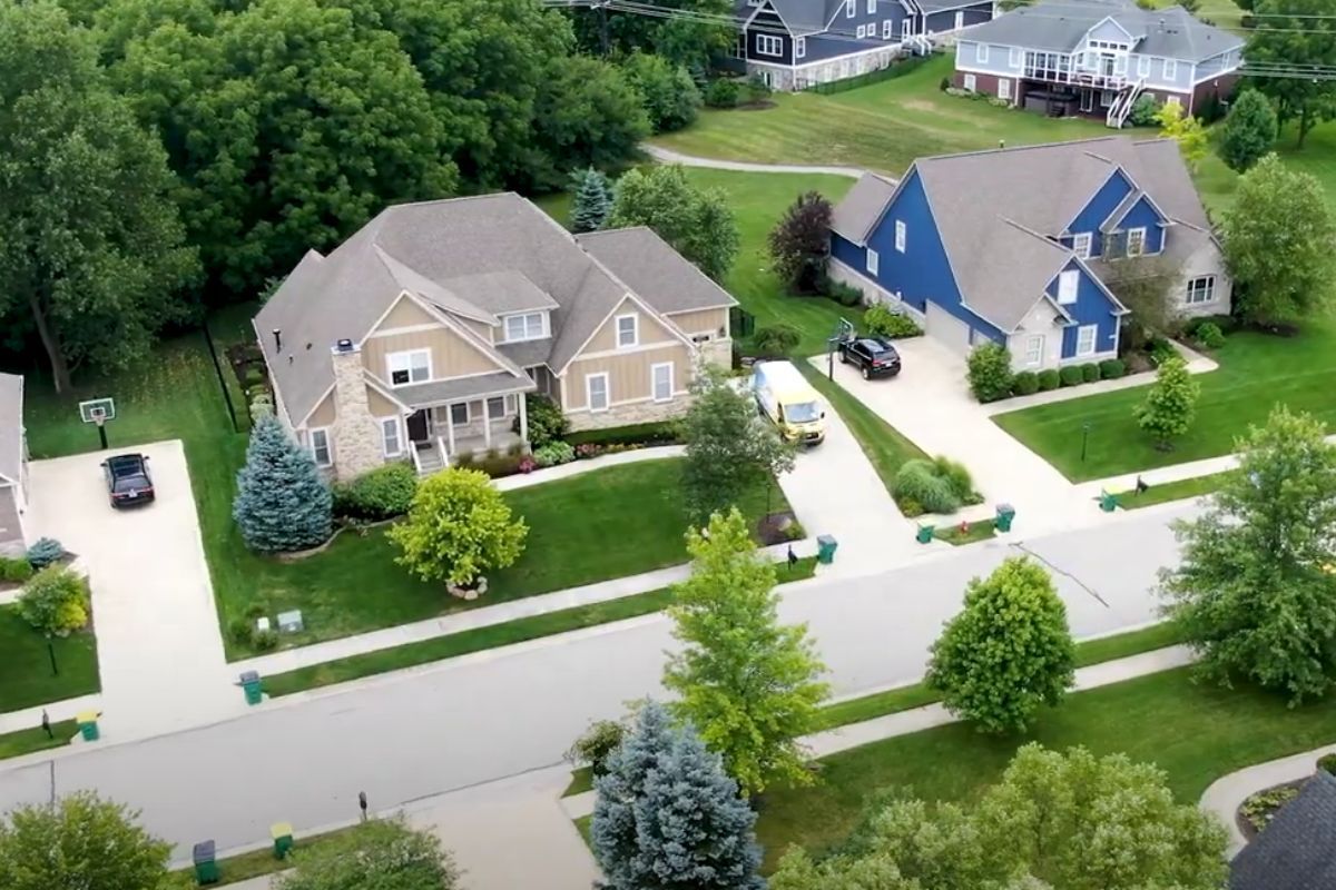An aerial view of a residential neighborhood with lots of houses and trees.