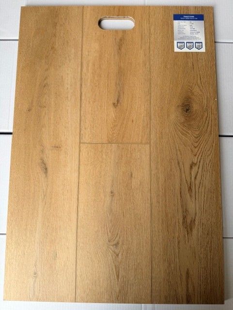 Wooden cutting board with handle and small label on the top right