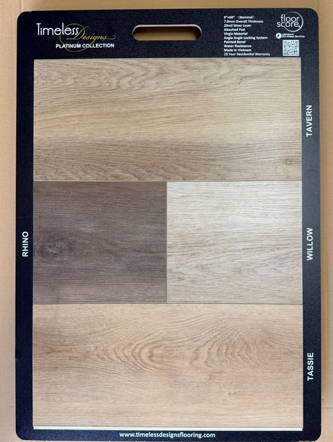 Wood-look laminate sample board with four oak-toned panels on a black backing card.