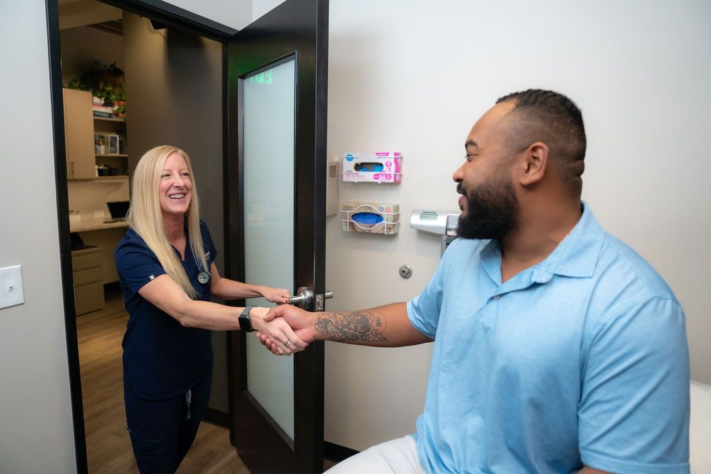 Cora Mattie greeting a patient at the clinic entrance.