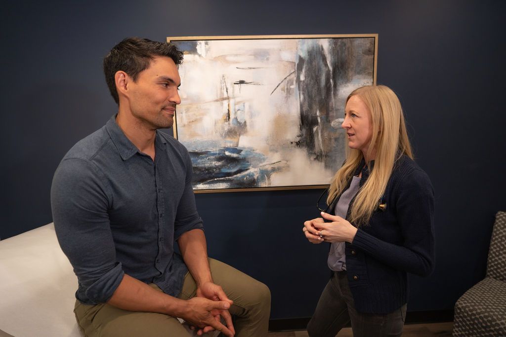 Cora Mattie, founder and physician associate, talking with male patient