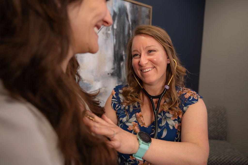 Photo of a Balanced Healthcare staff member, smiling during a patient conversation.