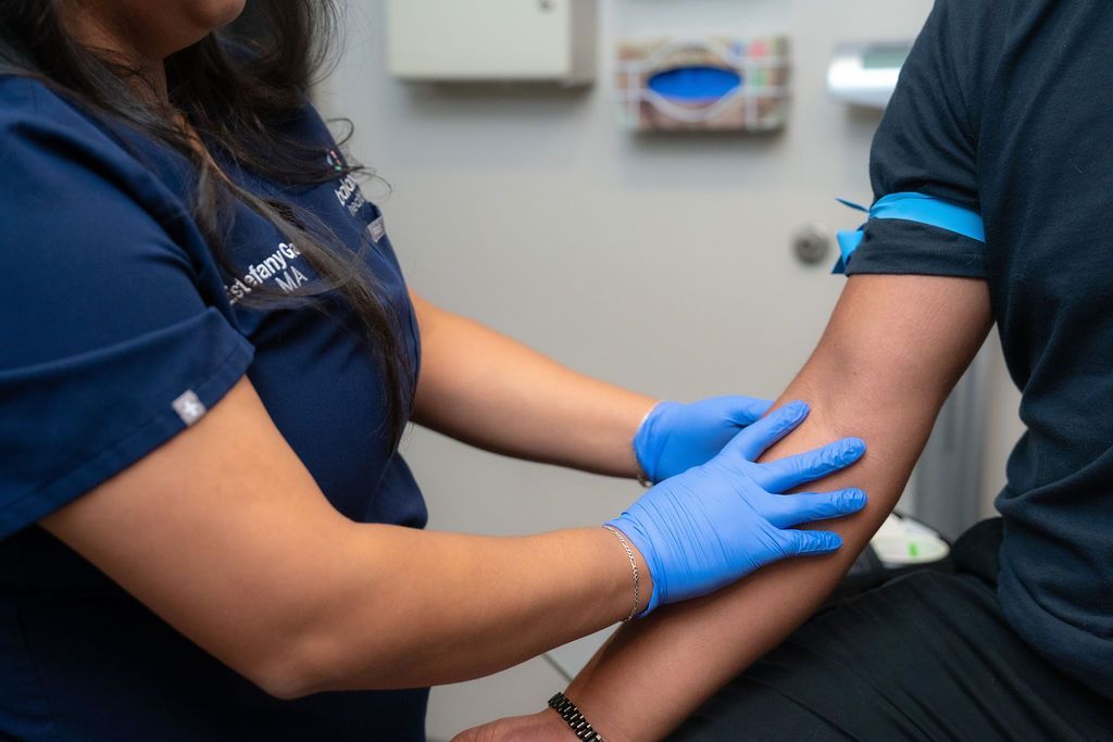 A nurse administering injection to male patient