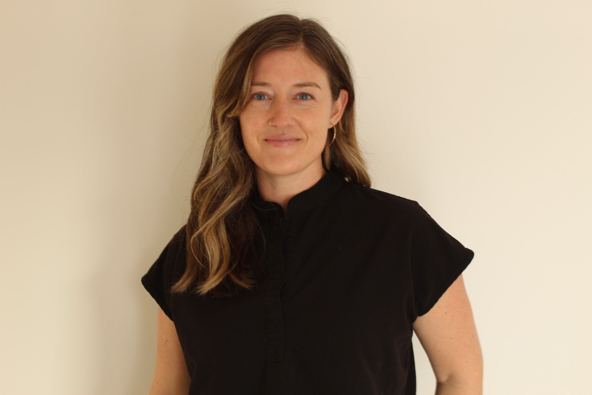 Jill Ramage smiling indoors, wearing a black top.