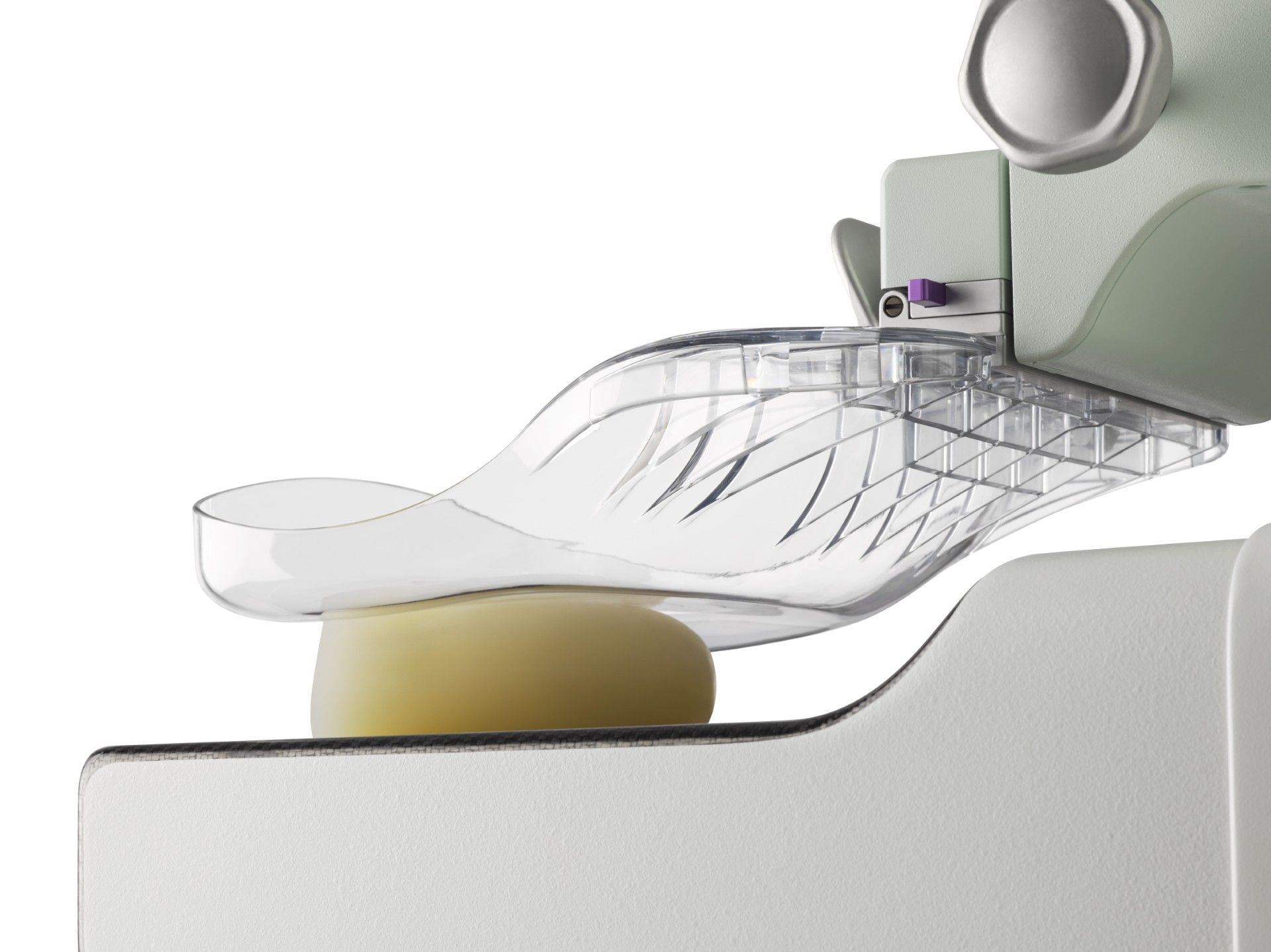 Close-up of a transparent foot brace or orthotic support wrapped around a foot on a cushion