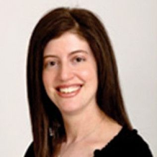 Smiling woman with long dark hair on a light background