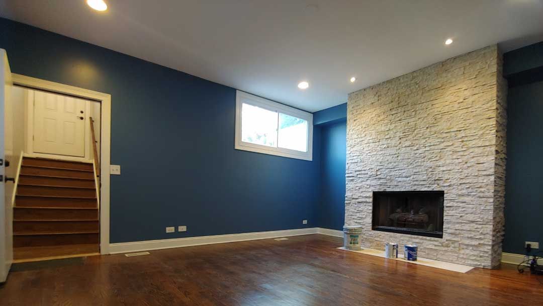 Painter applying fresh paint to an interior wall