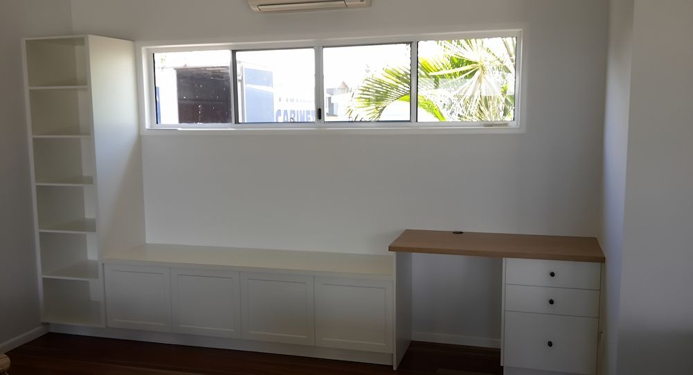 A Room With A Desk, Shelves, And A Window — Pioneer Cabinets in Sarina, QLD