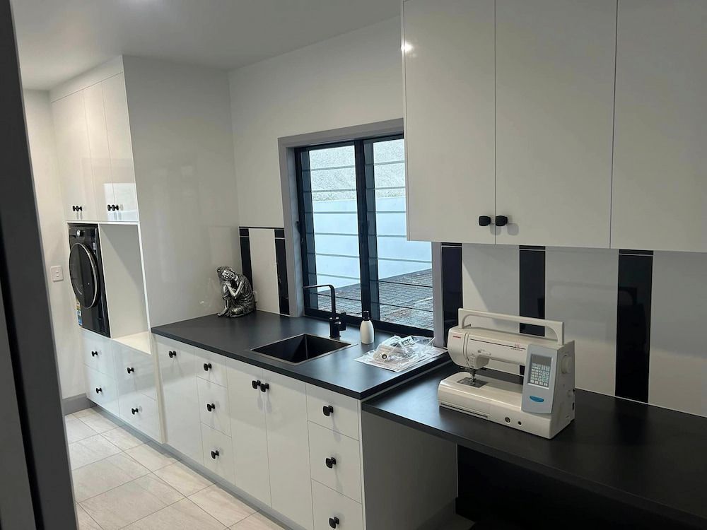 A Kitchen With White Cabinets And A Sewing Machine — Pioneer Cabinets in Airlie Beach, QLD