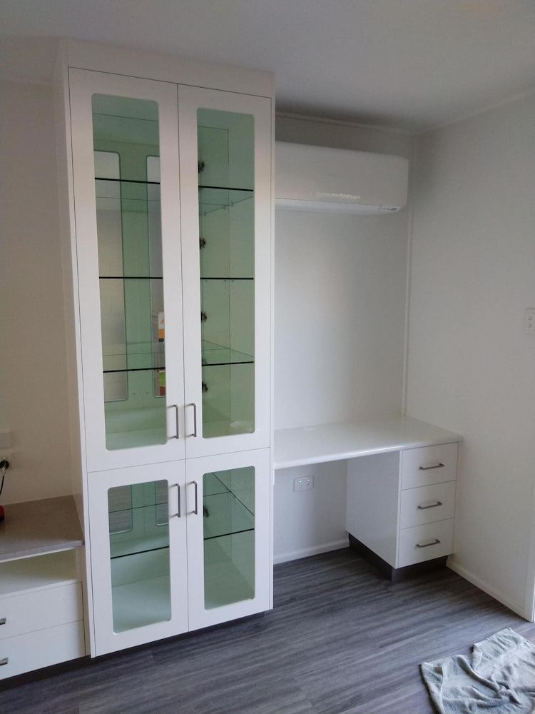 A Room With A Glass Cabinet And A Desk — Pioneer Cabinets in Paget, QLD