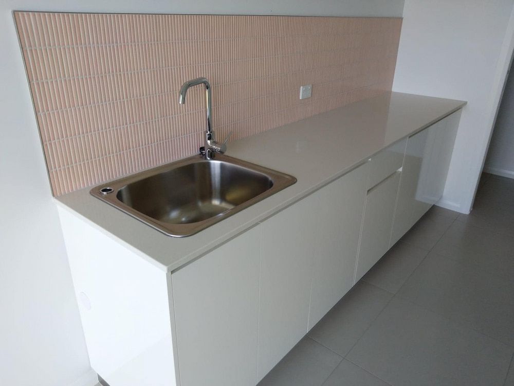 A Kitchen Counter With A Sink And A Faucet — Pioneer Cabinets in Paget, QLD