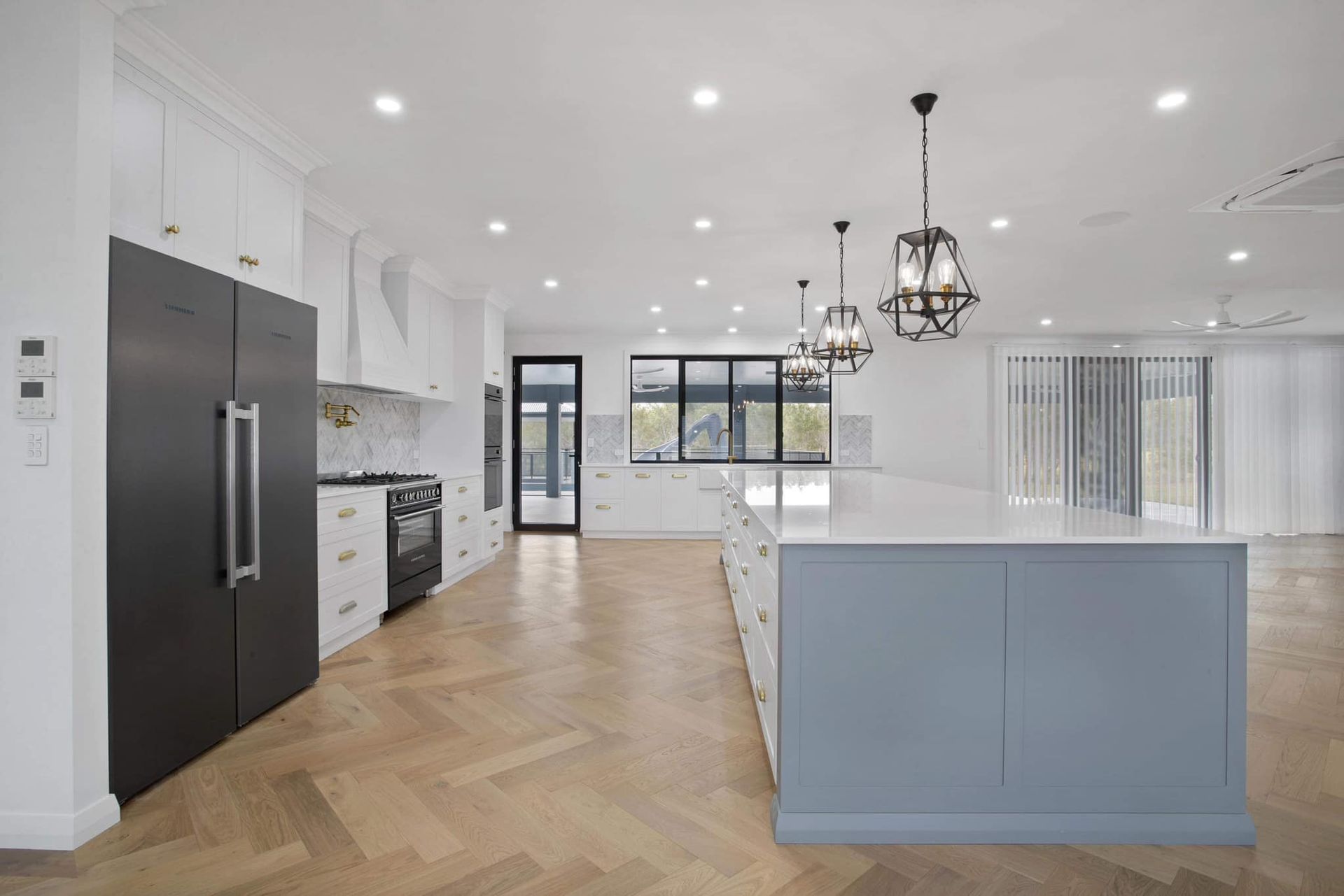 A Kitchen With White Cabinets And A Wooden Island — Pioneer Cabinets in Paget, QLD