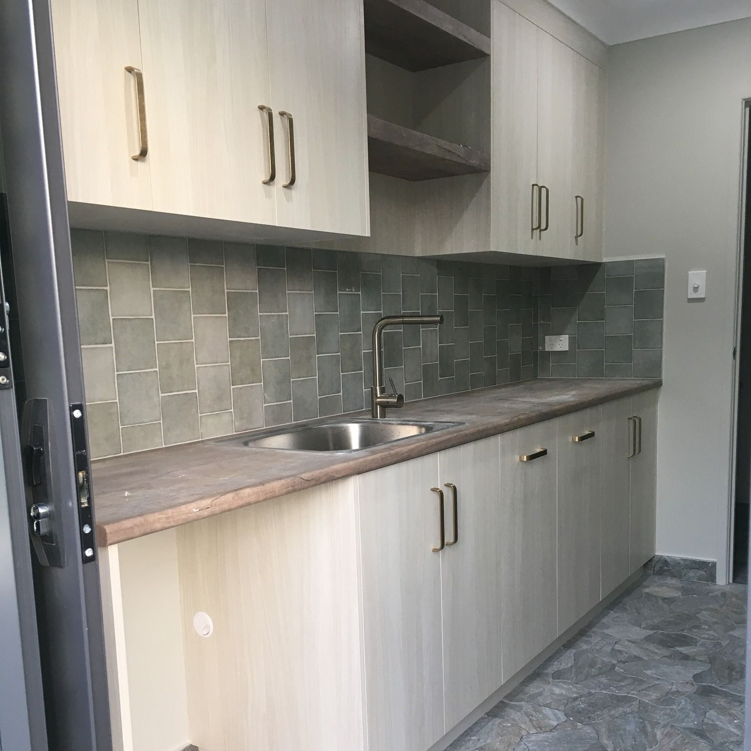 A Laundry Room With A Washer And Dryer And A Sink — Pioneer Cabinets in Paget, QLD