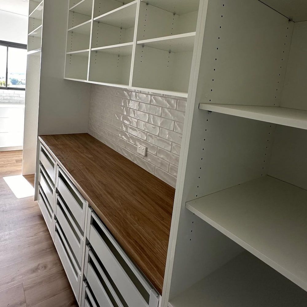 A Kitchen With A Wooden Countertop And White Shelves — Pioneer Cabinets in Paget, QLD